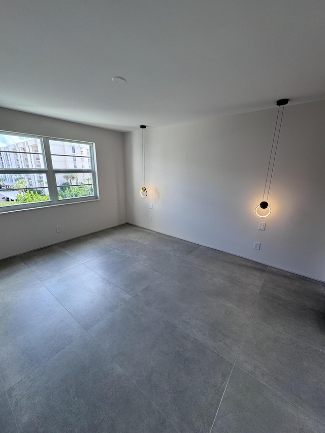 spare room with concrete floors