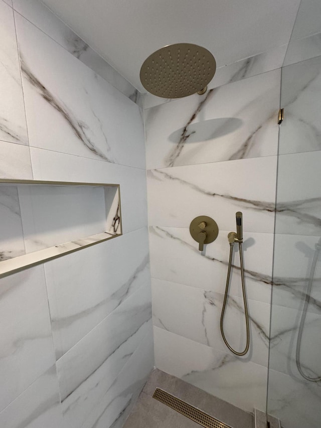 bathroom with a marble finish shower