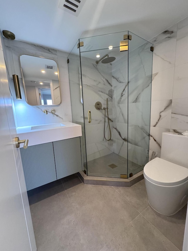 bathroom featuring toilet, vanity, a marble finish shower, and visible vents