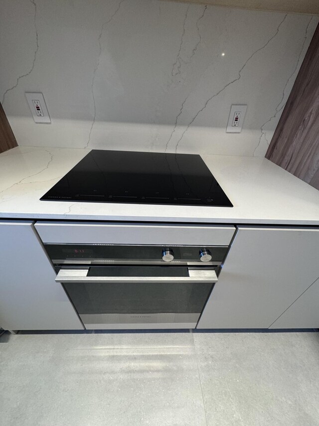 interior details featuring black electric stovetop and wall oven