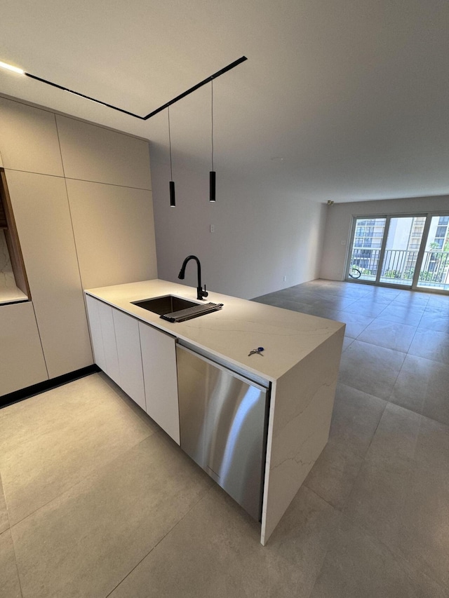 kitchen with a sink, white cabinetry, light countertops, stainless steel dishwasher, and modern cabinets