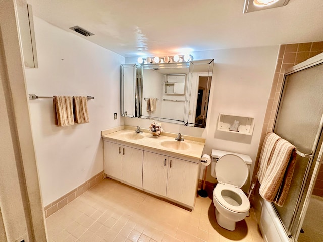 bathroom with tile patterned flooring, walk in shower, vanity, and toilet