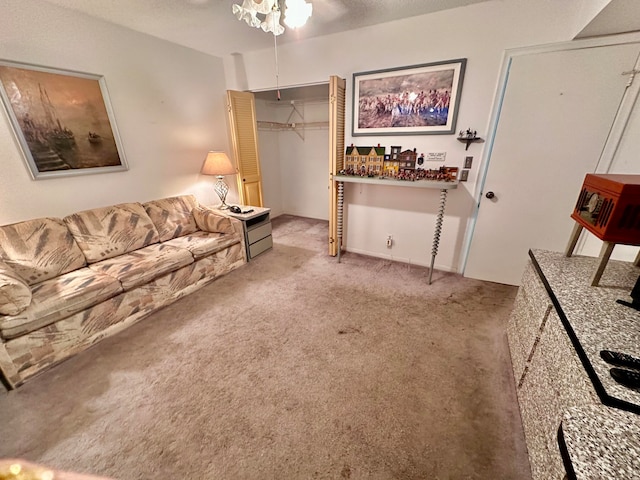 living room with a textured ceiling, ceiling fan, and light carpet