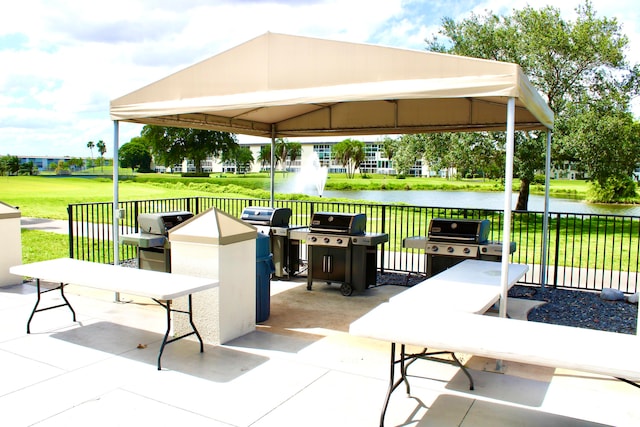 view of patio featuring a water view, a gazebo, and grilling area