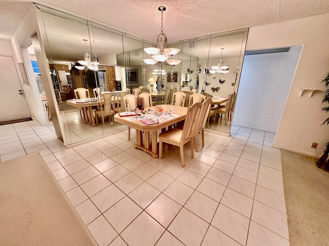 tiled dining room with a textured ceiling and a notable chandelier