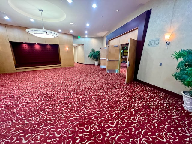 interior space featuring a tray ceiling and carpet flooring