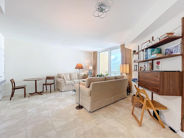 living room featuring light tile patterned flooring and expansive windows