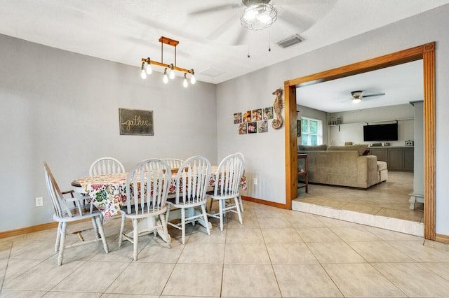 tiled dining space featuring ceiling fan