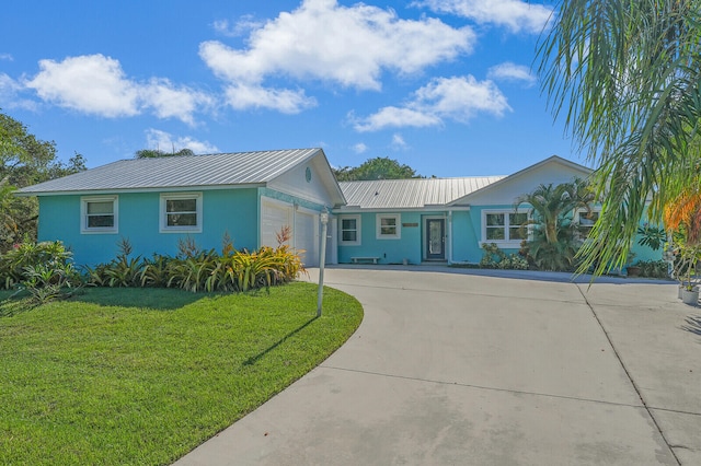 single story home featuring a front lawn and a garage