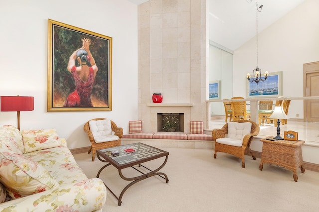 living area featuring a tile fireplace, carpet floors, high vaulted ceiling, and an inviting chandelier