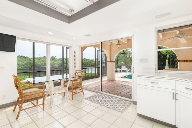 sunroom / solarium featuring ceiling fan and a healthy amount of sunlight