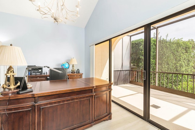 office with light hardwood / wood-style floors, vaulted ceiling, and a notable chandelier