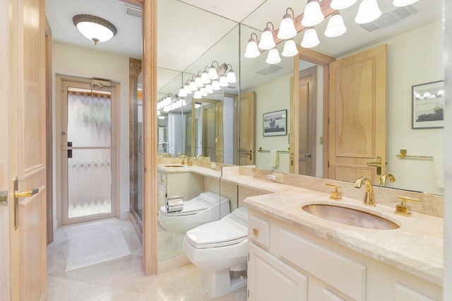 bathroom featuring tile patterned floors, vanity, and toilet