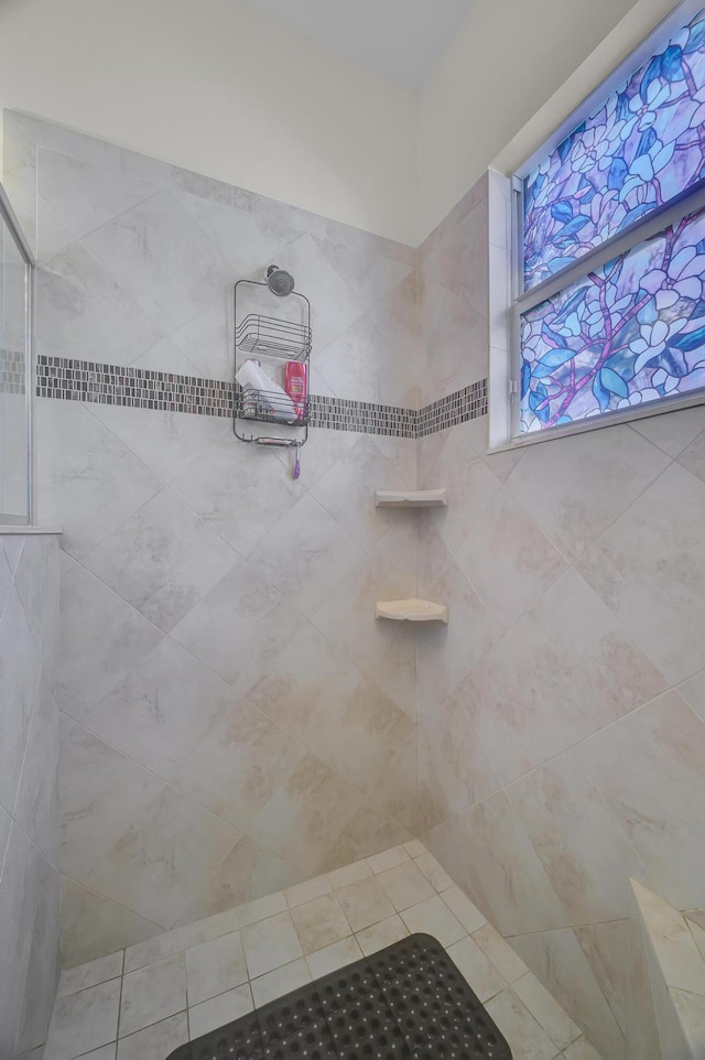 bathroom with a tile shower