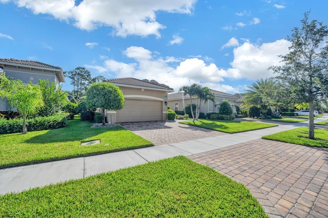 mediterranean / spanish house featuring a garage and a front lawn