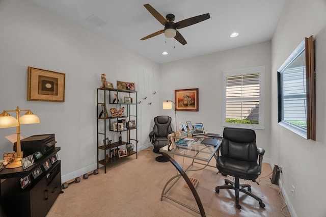 carpeted office space with ceiling fan