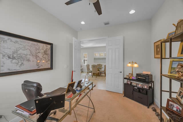 carpeted home office with ceiling fan