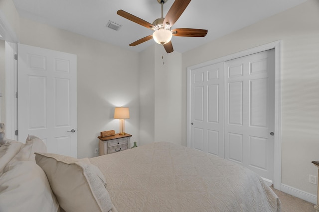 carpeted bedroom with a closet and ceiling fan