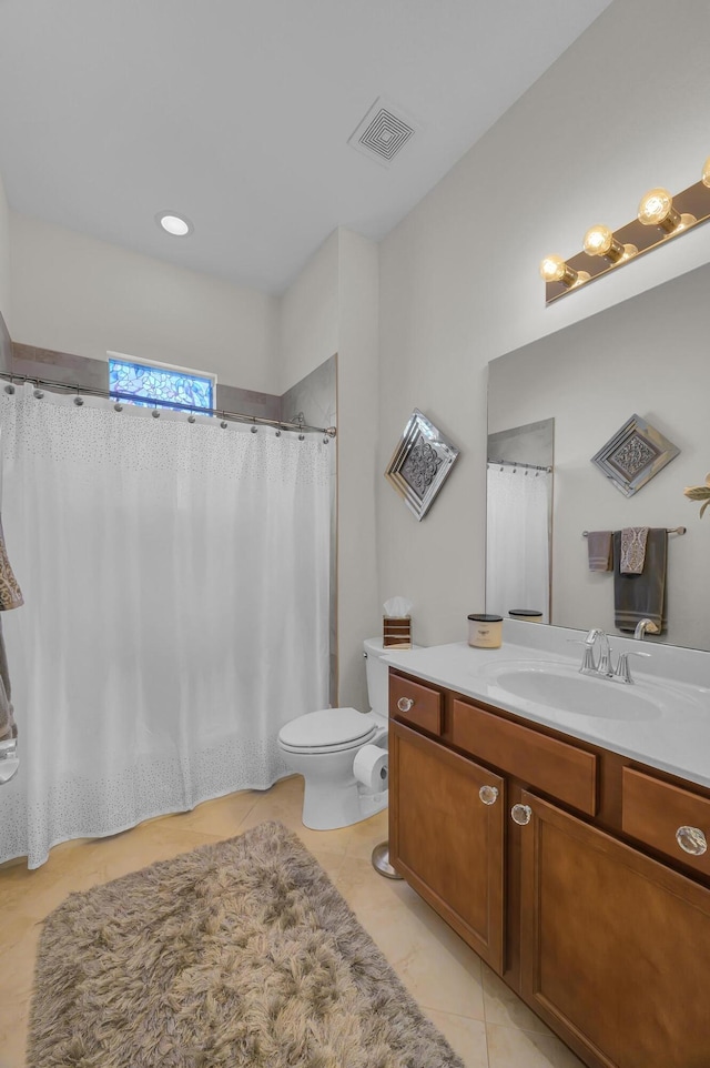 bathroom featuring tile patterned floors, toilet, and vanity