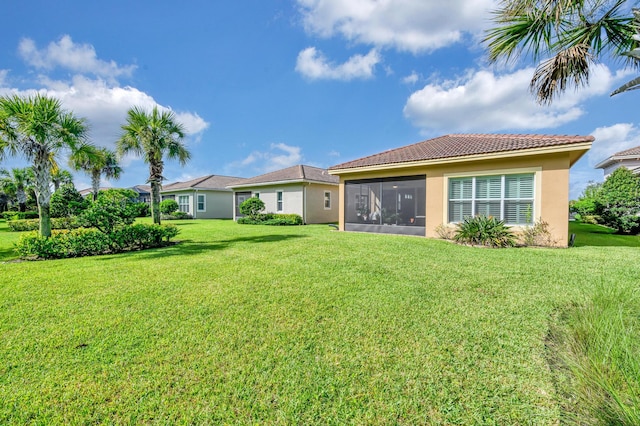 back of property featuring a lawn