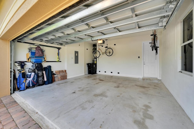 garage with electric panel and a garage door opener