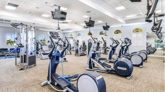 workout area featuring light carpet and a drop ceiling