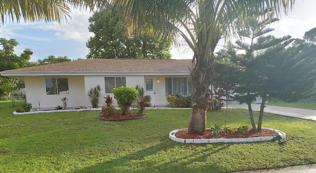 single story home featuring a front lawn