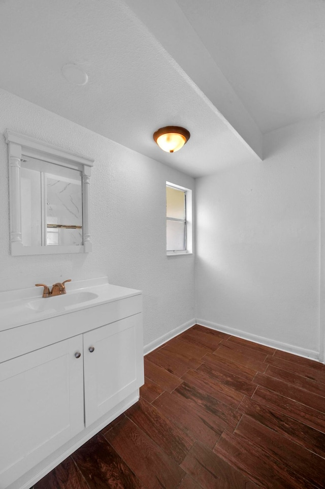 interior space with sink and dark wood-type flooring