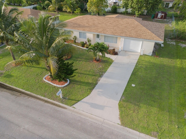 single story home featuring a front lawn and a garage