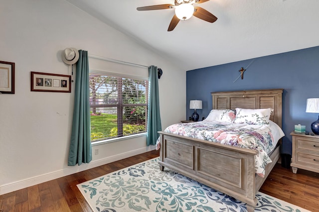 bedroom with ceiling fan, lofted ceiling, and dark wood-type flooring