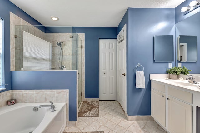 bathroom featuring tile patterned flooring, shower with separate bathtub, a wealth of natural light, and vanity