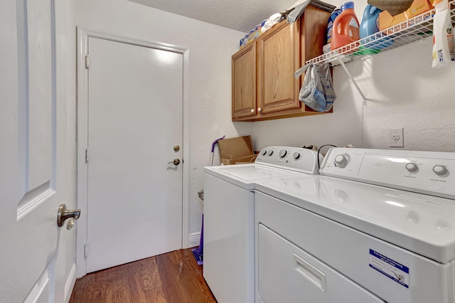 washroom with dark hardwood / wood-style floors, separate washer and dryer, cabinets, and a textured ceiling