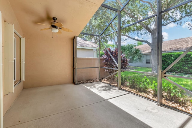 unfurnished sunroom featuring ceiling fan