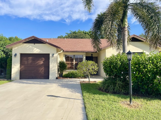 view of front of house featuring a garage and a front lawn