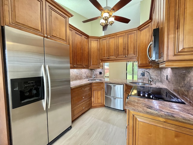 kitchen featuring stainless steel appliances, light hardwood / wood-style floors, decorative backsplash, and sink