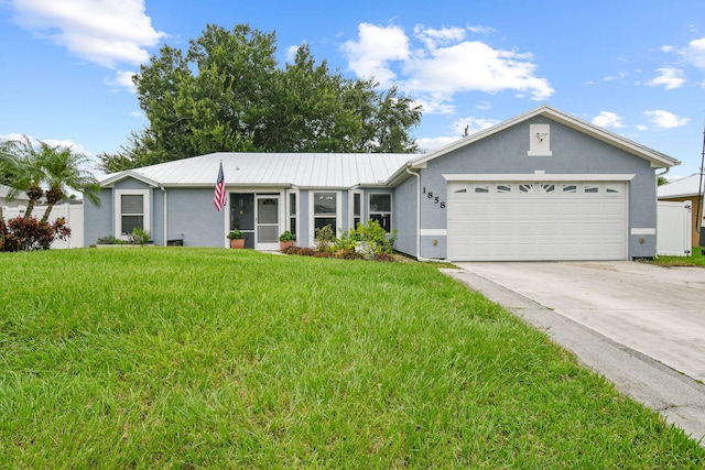 single story home featuring a front lawn and a garage