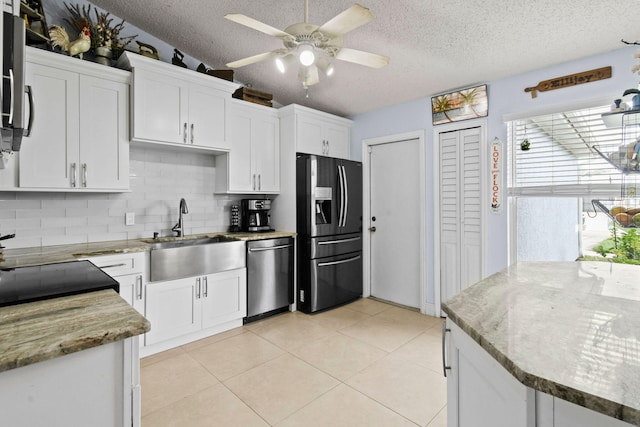 kitchen featuring white cabinets, backsplash, stainless steel appliances, and sink