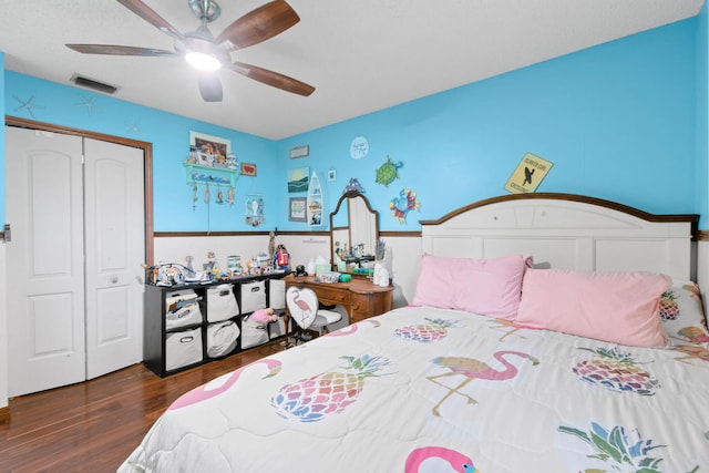 bedroom featuring ceiling fan, dark hardwood / wood-style flooring, and a closet