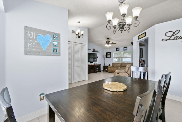 dining room with light tile patterned flooring, a textured ceiling, lofted ceiling, and ceiling fan with notable chandelier