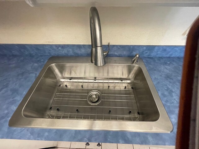 room details with tile patterned flooring and sink