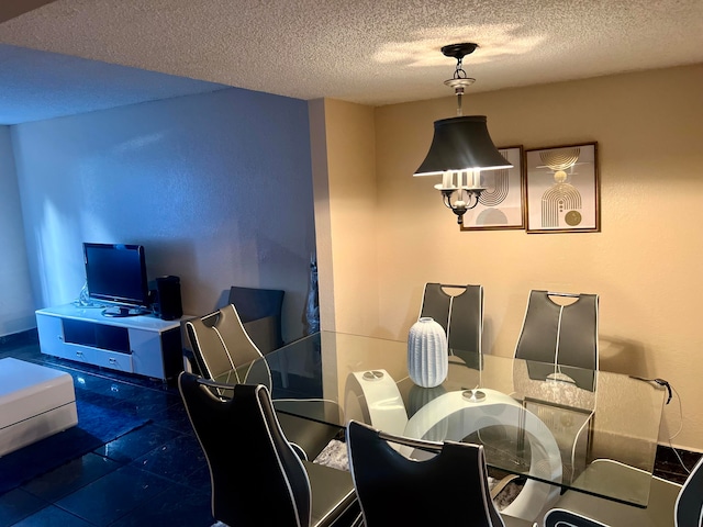 dining space featuring a textured ceiling