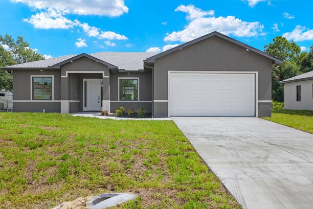 single story home featuring a front yard and a garage