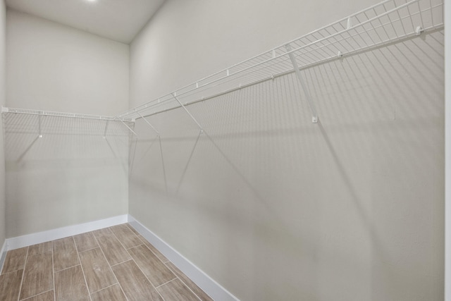 spacious closet with light hardwood / wood-style flooring