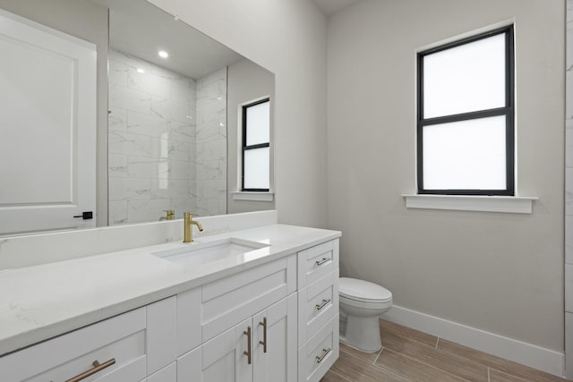 bathroom featuring vanity, tile patterned flooring, and toilet