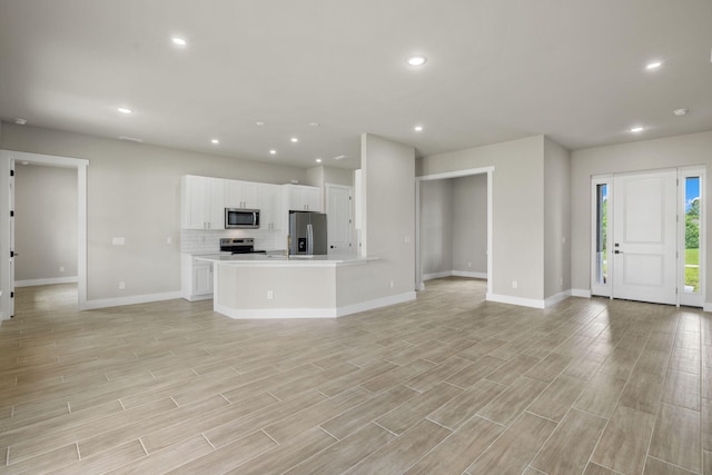 unfurnished living room featuring light hardwood / wood-style floors