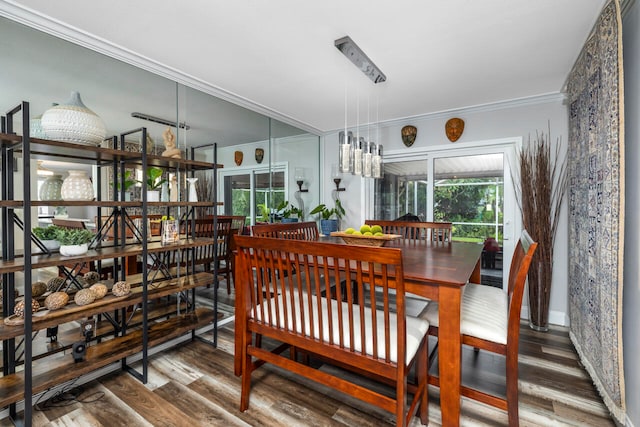 dining space with hardwood / wood-style floors and crown molding