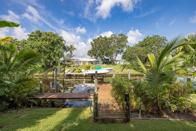 dock area featuring a water view and a yard