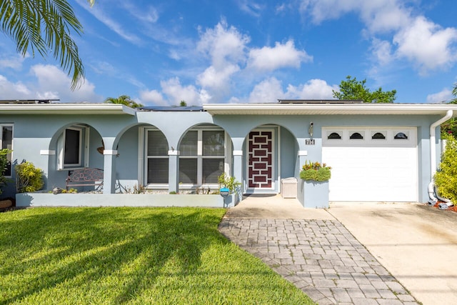 ranch-style house featuring a front yard and a garage