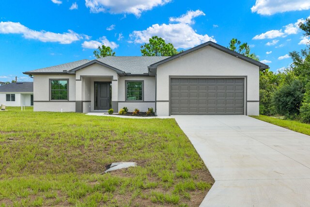 view of front of house featuring a front yard and a garage