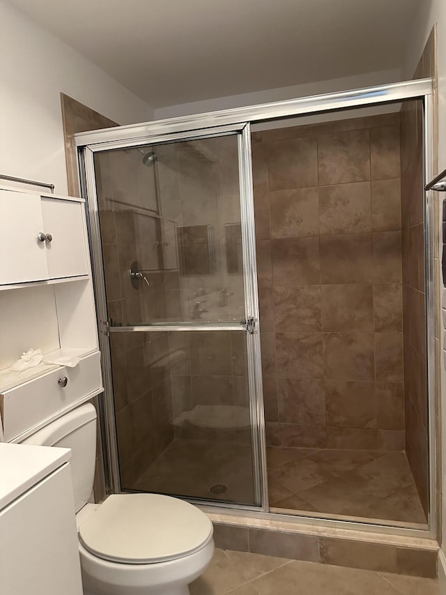 bathroom featuring an enclosed shower and toilet